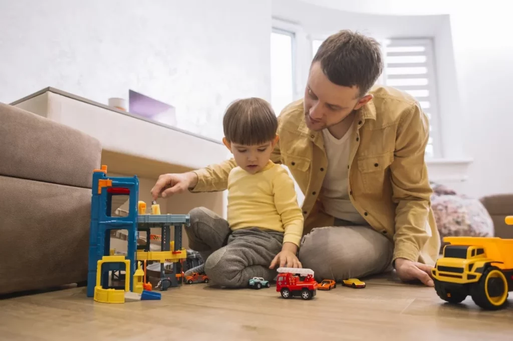 a person and child playing with toys